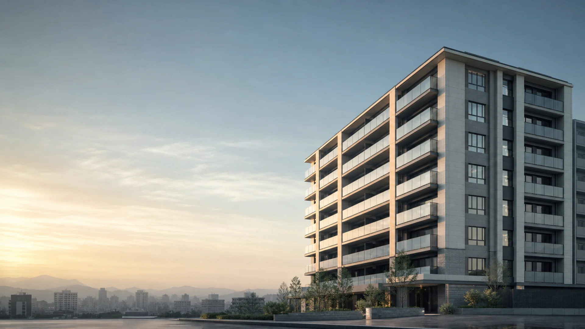 A new-build condominium on the morning of completion, standing quietly beneath a bright sky.